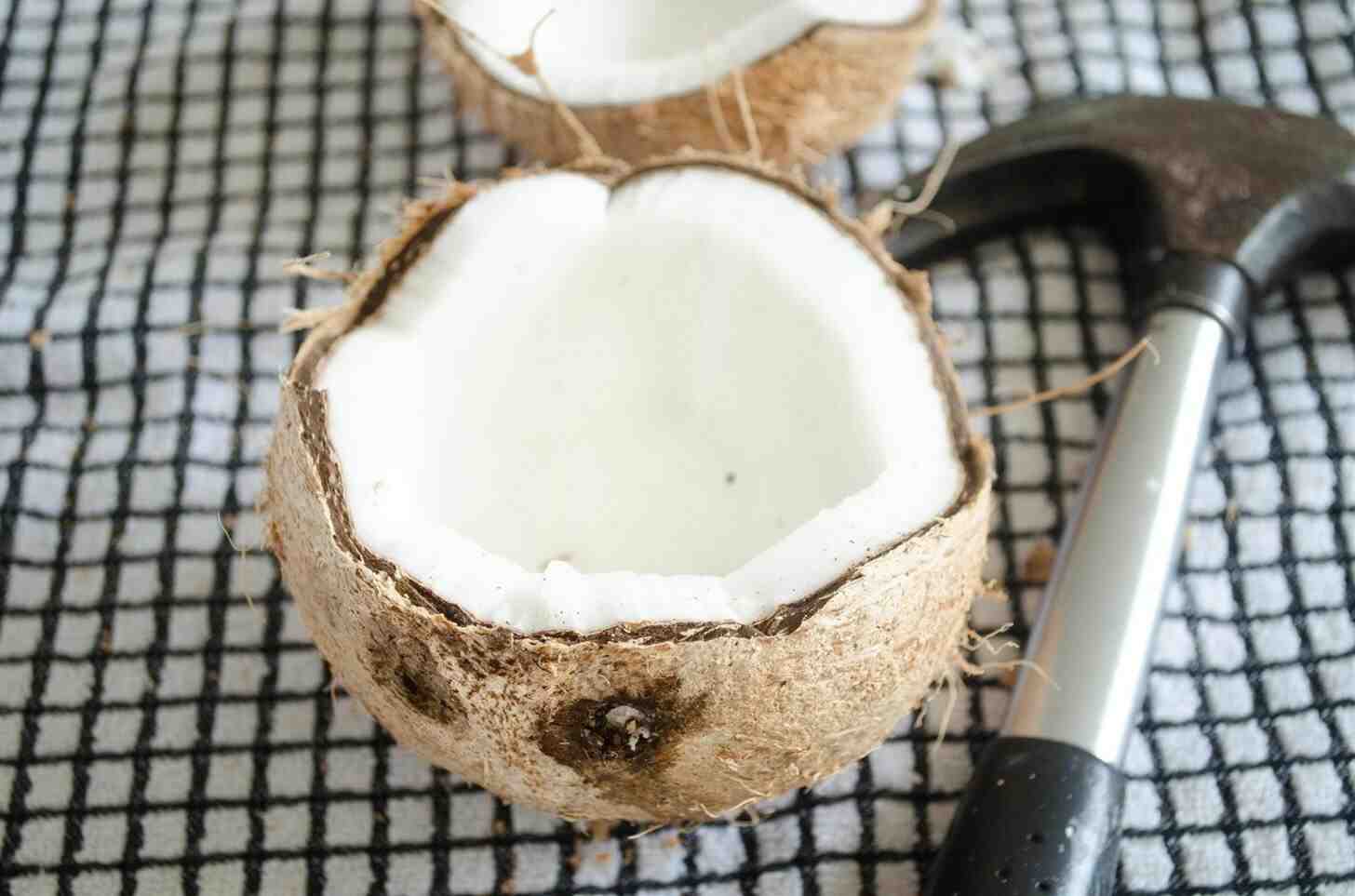 How do you break a coconut without losing water?